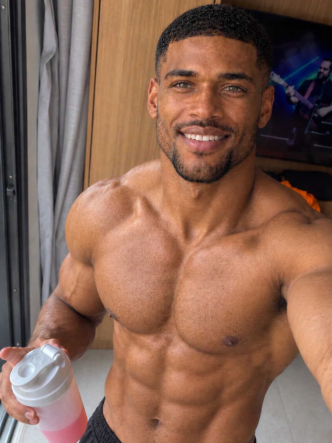 Post-workout selfie of Ayo holding a protein shaker